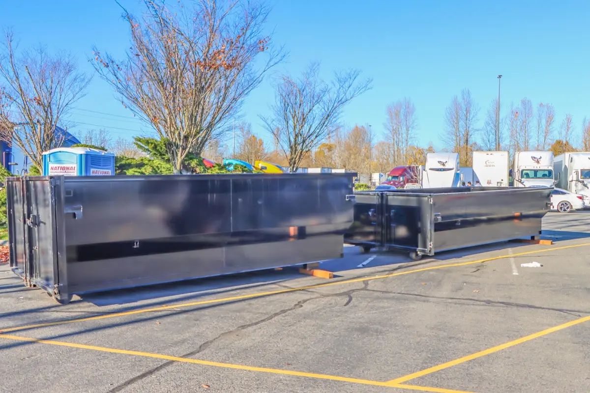 Professional dumpster rental service with roll-off container on residential driveway in South Gate